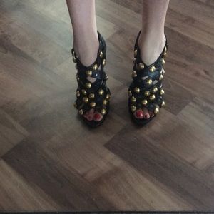 Gucci sandal heels with gold stud embellishment.